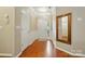 Inviting foyer featuring hardwood floors, decorative mirror, and crown molding at 13505 Michael Lynn Rd, Charlotte, NC 28278