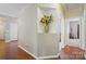 Neutral hallway with decorative niche, hardwood floors, and white trim at 13505 Michael Lynn Rd, Charlotte, NC 28278