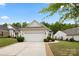 View of the side and front of home featuring an attached garage, manicured lawn, and mature trees at 1488 River Bend Blvd, Fort Mill, SC 29707