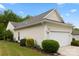 Home featuring an attached two-car garage, manicured lawn, and mature trees at 1488 River Bend Blvd, Fort Mill, SC 29707