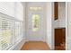 Inviting foyer featuring a decorative glass front door, hardwood floors, and natural light at 1488 River Bend Blvd, Fort Mill, SC 29707