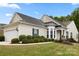 Charming home featuring a well-manicured lawn, attached two-car garage, and inviting architectural details at 1488 River Bend Blvd, Fort Mill, SC 29707