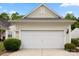 Spacious two-car garage with a pristine white door and manicured bushes at 1488 River Bend Blvd, Fort Mill, SC 29707