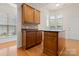 Eat-in kitchen featuring an island, granite countertops, and wooden cabinetry at 1488 River Bend Blvd, Fort Mill, SC 29707