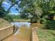 Close up view of the lake access and boat launch with mature trees reflecting on the water at 1488 River Bend Blvd, Fort Mill, SC 29707