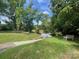 Scenic lake view with bench seating available amongst mature trees on a manicured lawn on a sunny day at 1488 River Bend Blvd, Fort Mill, SC 29707