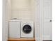 Functional laundry room featuring a washer, dryer, and storage shelving at 1488 River Bend Blvd, Fort Mill, SC 29707