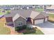 Aerial view of a two-story home with stone and siding, three-car garage and a green lawn at 164 Castle Pines Ln, Statesville, NC 28625