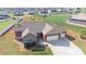 Aerial view of a two-story home with stone and siding, three-car garage, green lawn, and neighborhood at 164 Castle Pines Ln, Statesville, NC 28625