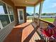 Cozy back porch with wood floors, white columns, an American flag chair, and a view of the backyard at 164 Castle Pines Ln, Statesville, NC 28625