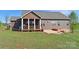Exterior view of the back of the home showcasing the porch, windows, siding, and green lawn at 164 Castle Pines Ln, Statesville, NC 28625