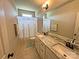 Well-lit bathroom featuring a double vanity, granite countertops, and a decorative shower curtain at 164 Castle Pines Ln, Statesville, NC 28625