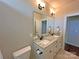 Clean bathroom featuring a double vanity with granite countertops and modern light fixtures at 164 Castle Pines Ln, Statesville, NC 28625
