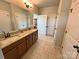 Spacious bathroom featuring a double vanity with granite countertops and ample cabinet space at 164 Castle Pines Ln, Statesville, NC 28625