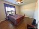 Bedroom with hardwood floors, a comfortable bed, and elegant purple drapes at 164 Castle Pines Ln, Statesville, NC 28625