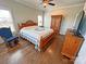 A cozy bedroom with wood flooring, a ceiling fan, and a beautiful quilt on the wooden bed frame at 164 Castle Pines Ln, Statesville, NC 28625