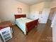 Bedroom with hardwood floors, a cozy bed, and access to closet and other rooms at 164 Castle Pines Ln, Statesville, NC 28625