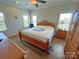 Cozy bedroom showcasing hardwood floors, natural light, and a comfortable bed, offering a peaceful retreat at 164 Castle Pines Ln, Statesville, NC 28625
