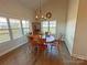 Charming dining room featuring a wood table, ample natural light, and hardwood floors, perfect for gatherings at 164 Castle Pines Ln, Statesville, NC 28625