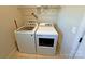 Bright laundry room with a white, front-loading washer and dryer set at 164 Castle Pines Ln, Statesville, NC 28625