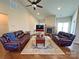Inviting living room featuring a stone fireplace, hardwood floors, vaulted ceilings, and comfortable seating for relaxation at 164 Castle Pines Ln, Statesville, NC 28625