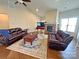 Inviting living room featuring a stone fireplace, hardwood floors, vaulted ceilings, and comfortable seating for relaxation at 164 Castle Pines Ln, Statesville, NC 28625