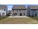 The exterior rear view of the home includes a fenced yard, concrete patio, and gray siding at 184 Tetcott St, Mooresville, NC 28115