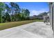 Wide concrete patio and large backyard features tall trees, iron fencing and neighboring houses at 184 Tetcott St, Mooresville, NC 28115