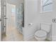 Bright bathroom with a neutral tile floor, toilet, and shower and tub with a patterned curtain at 184 Tetcott St, Mooresville, NC 28115