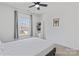 This naturally lit bedroom features a large window, a ceiling fan, and a closet with shelving at 184 Tetcott St, Mooresville, NC 28115