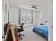 This carpeted bedroom features a ceiling fan, a large window, and space for an office at 184 Tetcott St, Mooresville, NC 28115