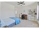 Bright bedroom features a ceiling fan, an art easel, a desk, and built-in bookshelves at 184 Tetcott St, Mooresville, NC 28115