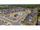 A high-angle view of the community pool area with a parking lot and lush greenery at 184 Tetcott St, Mooresville, NC 28115
