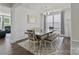 Stylish dining room with hardwood floors, decorative moldings, and an elegant chandelier above a dining table at 184 Tetcott St, Mooresville, NC 28115