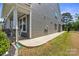 Exterior view features a stone and column-lined porch, gray siding, green grass and sunny skies at 184 Tetcott St, Mooresville, NC 28115