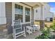 Charming front porch featuring rocking chairs and stone accents, perfect for relaxing outdoors at 184 Tetcott St, Mooresville, NC 28115