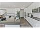 Modern kitchen features white cabinetry, stainless steel appliances, and a large island with sink at 184 Tetcott St, Mooresville, NC 28115