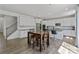 Bright kitchen and dining area features white cabinets, stainless appliances, and wood floors at 184 Tetcott St, Mooresville, NC 28115