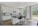 Modern kitchen featuring white cabinets, dark countertops, stainless steel appliances and a kitchen island at 184 Tetcott St, Mooresville, NC 28115