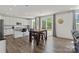 Modern kitchen with white cabinets, stainless steel appliances, and a kitchen island with barstool seating at 184 Tetcott St, Mooresville, NC 28115