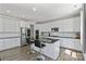 Beautiful kitchen featuring white cabinets, stainless steel appliances, an island with seating, and hardwood floors at 184 Tetcott St, Mooresville, NC 28115