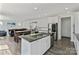 Open-concept living room with fireplace seamlessly connects to kitchen and dining area at 184 Tetcott St, Mooresville, NC 28115