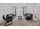 Upstairs living room features large windows, contemporary furniture, and a tranquil atmosphere at 184 Tetcott St, Mooresville, NC 28115