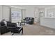 Upstairs living room features large windows, contemporary furniture, and a tranquil atmosphere at 184 Tetcott St, Mooresville, NC 28115