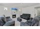 Comfortable living room features a fireplace, large television and neutral color palette at 184 Tetcott St, Mooresville, NC 28115