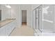 Bright main bathroom featuring a glass shower, double sinks, a soaking tub, and a walk-in closet at 184 Tetcott St, Mooresville, NC 28115