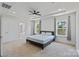Spacious main bedroom features neutral colors, a ceiling fan, and windows that let in plenty of natural light at 184 Tetcott St, Mooresville, NC 28115