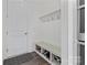 Mudroom with built-in bench, storage cubbies, coat hooks, and a door to the garage at 184 Tetcott St, Mooresville, NC 28115