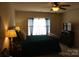 Comfortable bedroom with a ceiling fan, dark trim and a TV at 1960 Aston Mill Pl, Charlotte, NC 28273