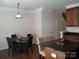 Bright dining room with dark wood floors and a contemporary light fixture at 1960 Aston Mill Pl, Charlotte, NC 28273